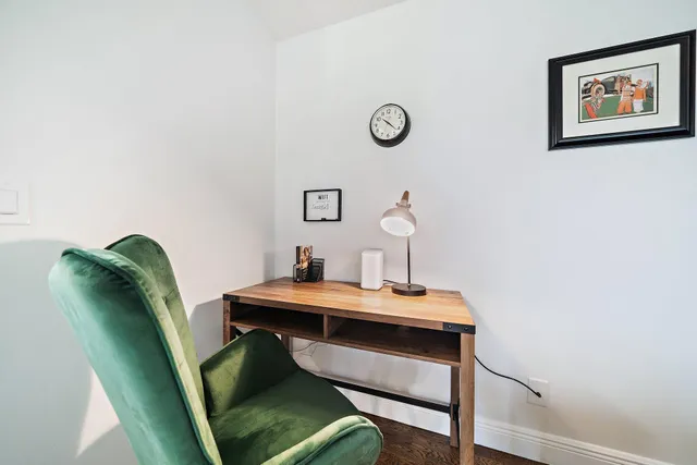 a view of a workspace with furniture and wooden floor