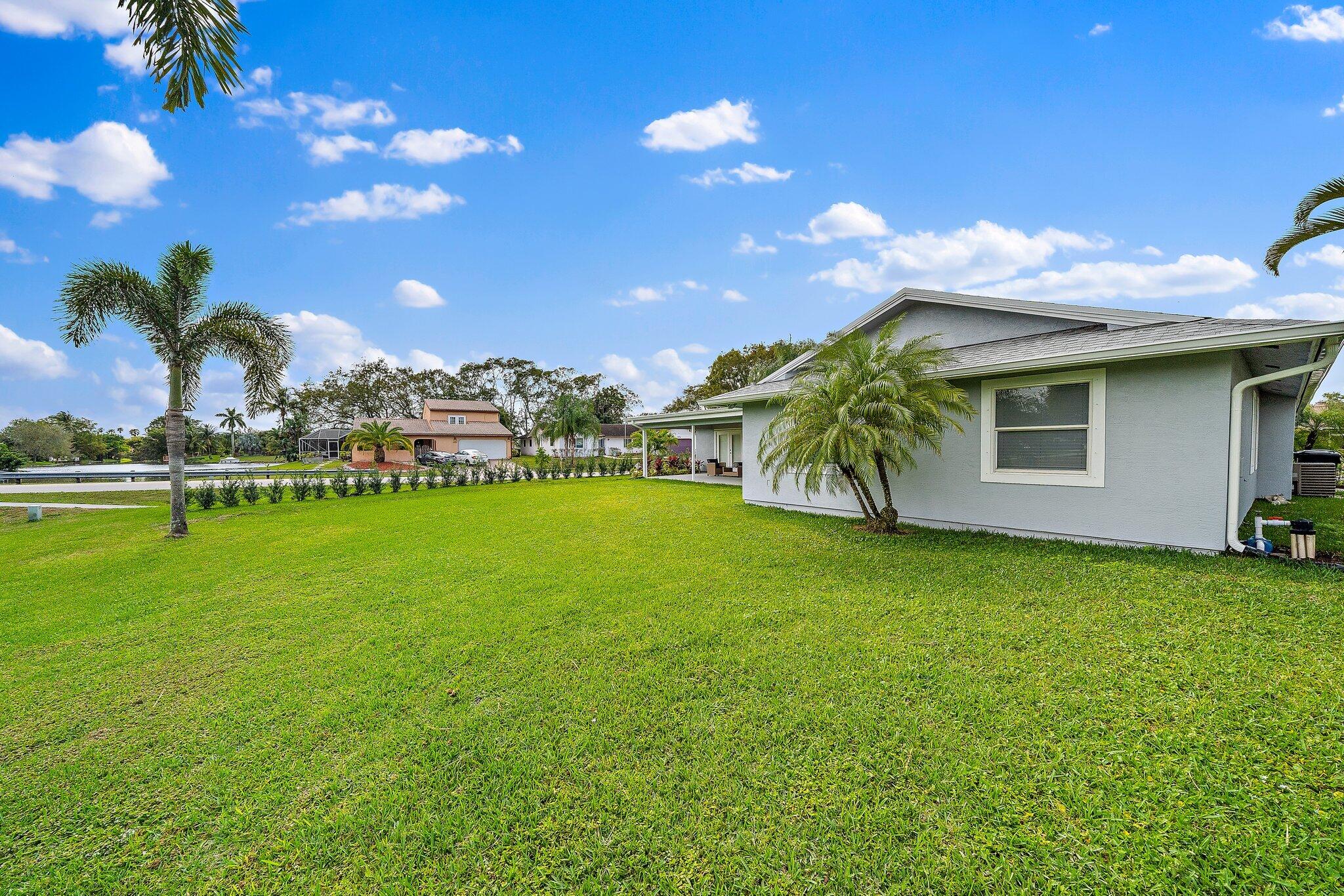 1342 Essex Drive Wellington, FL 33414 - Photo 54 of 58 a view of a house with a yard