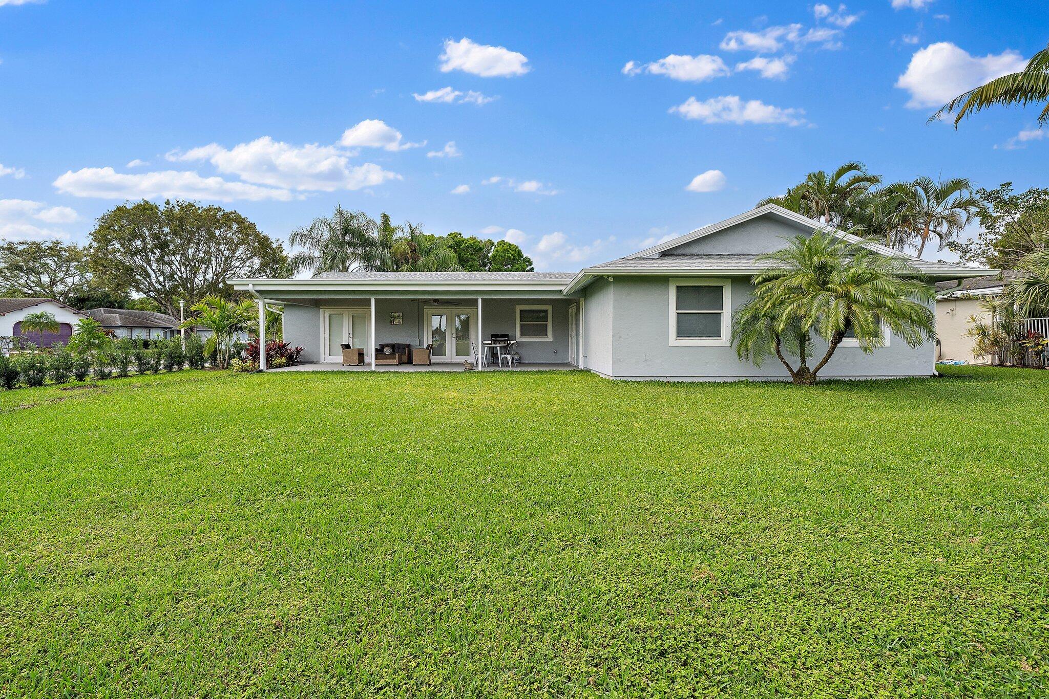 1342 Essex Drive Wellington, FL 33414 - Photo 55 of 58 a view of a house with a big yard