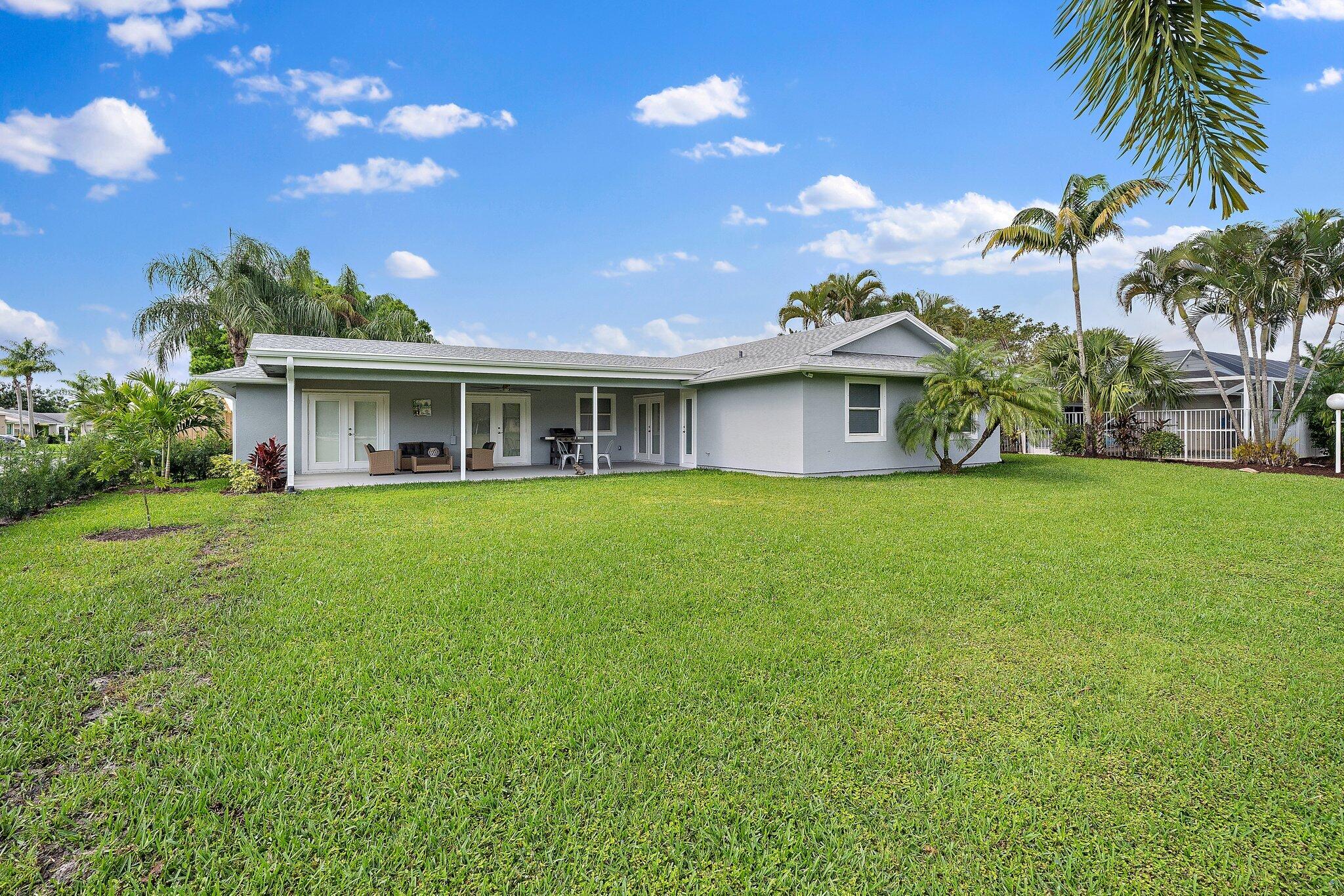 1342 Essex Drive Wellington, FL 33414 - Photo 56 of 58 a front view of house with yard and green space