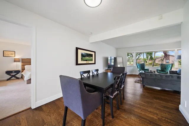 a dining room with furniture and wooden floor