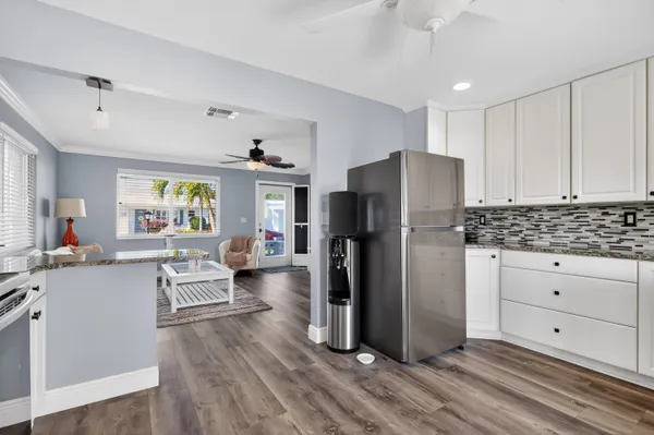a kitchen with white cabinets and stainless steel appliances