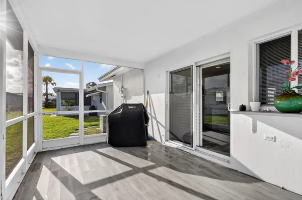 a living room with furniture a front door and windows