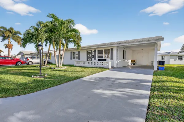 a house with palm tree in front of it