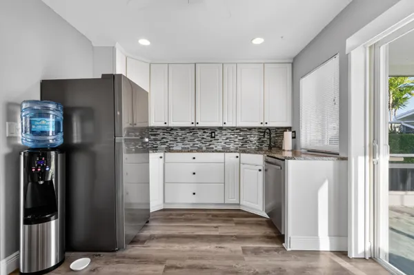 a kitchen with stainless steel appliances granite countertop a refrigerator and a stove