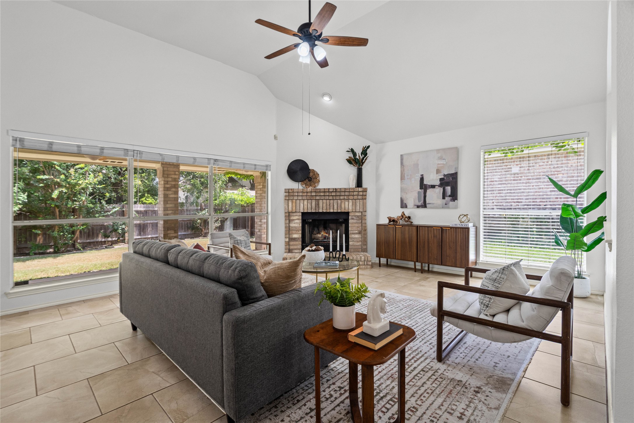 2920 Warwick Way Austin, TX 78748 - Photo 11 of 36 A vaulted ceiling living area features an elegant brick fireplace and serene views of the private backyard