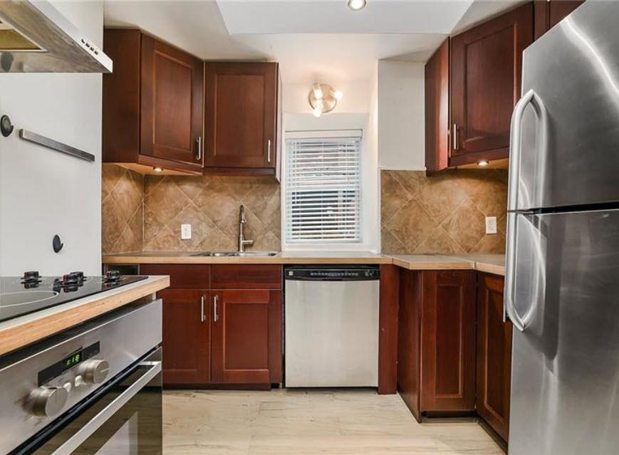 140 Home Street Pittsburgh, PA 15201 - Photo 11 of 25 a kitchen with stainless steel appliances granite countertop a refrigerator and a stove
