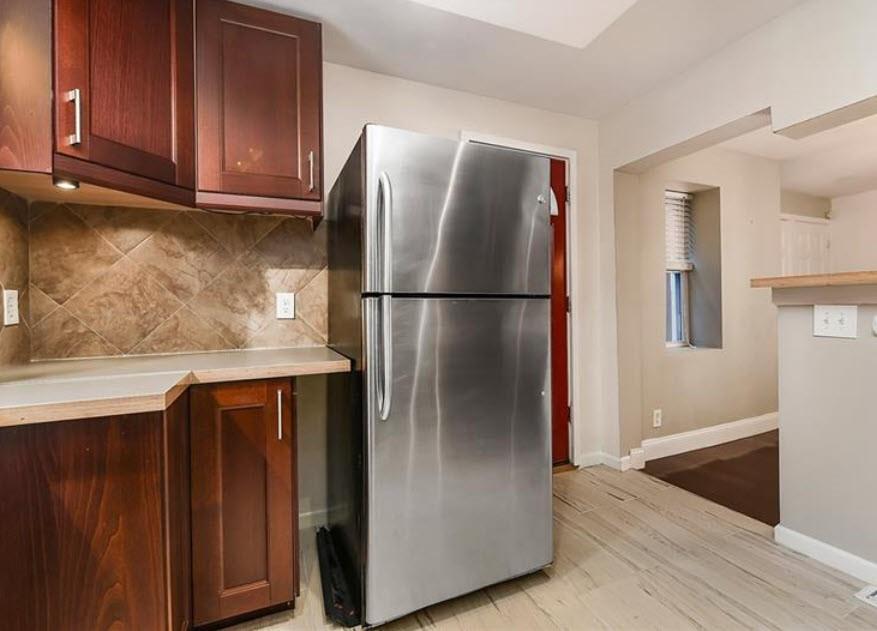 140 Home Street Pittsburgh, PA 15201 - Photo 12 of 25 a metallic refrigerator freezer sitting in a kitchen