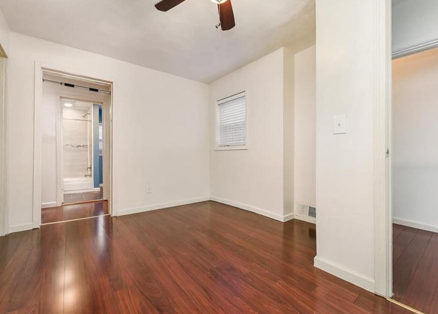140 Home Street Pittsburgh, PA 15201 - Photo 17 of 25 an empty room with wooden floor cabinet and windows