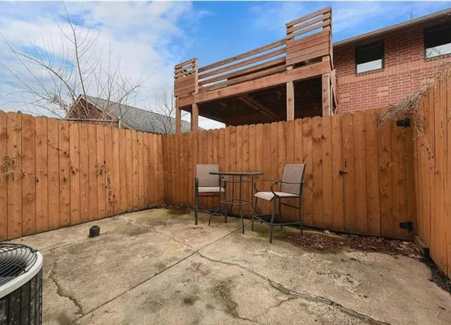 a backyard of a house with barbeque oven table and chairs