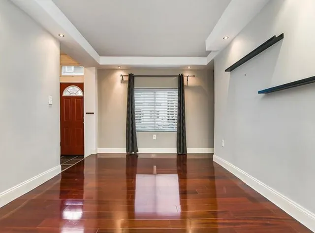 a view of an entryway of a house and wooden floor