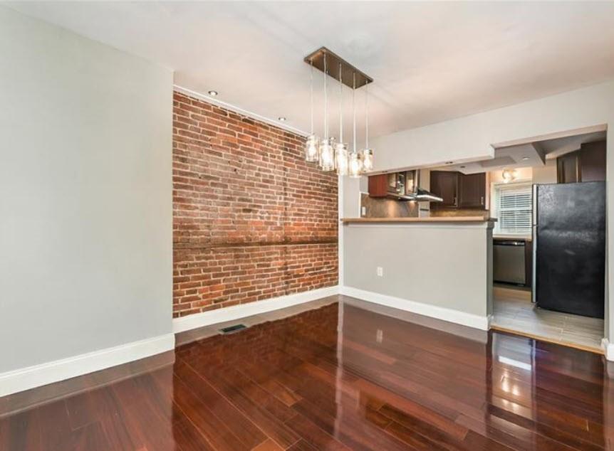 140 Home Street Pittsburgh, PA 15201 - Photo 6 of 25 a view of a kitchen with wooden floor and a refrigerator