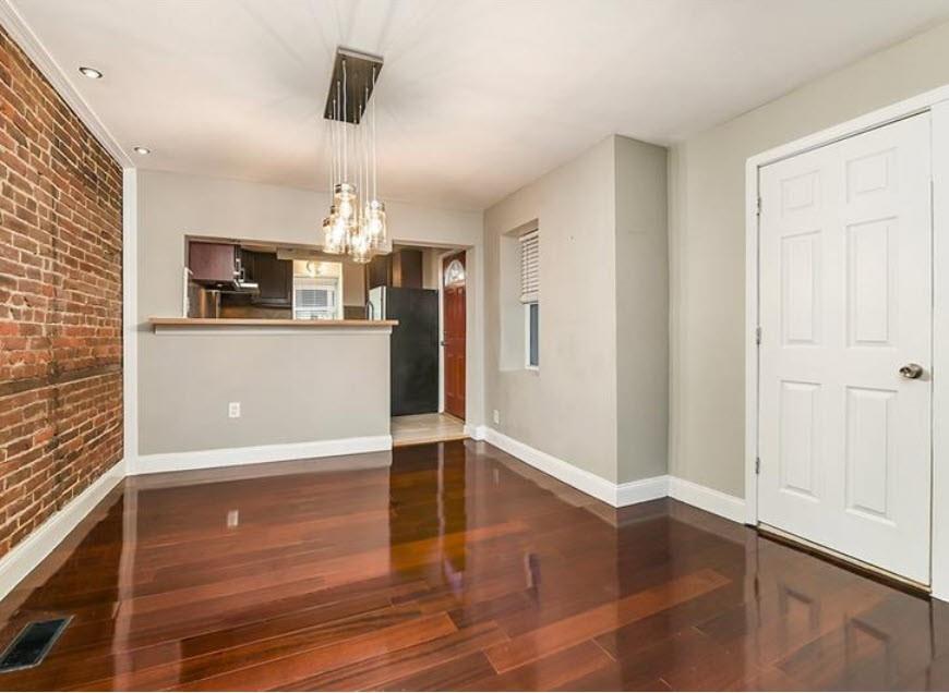 140 Home Street Pittsburgh, PA 15201 - Photo 7 of 25 a view of a livingroom with wooden floor and kitchen space