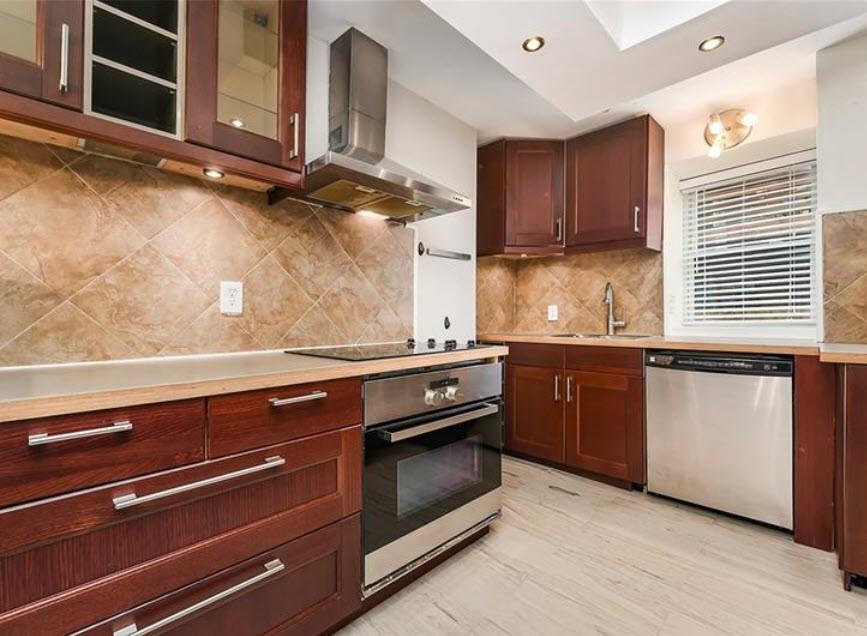 140 Home Street Pittsburgh, PA 15201 - Photo 10 of 25 a kitchen with granite countertop a stove cabinets and wooden floor
