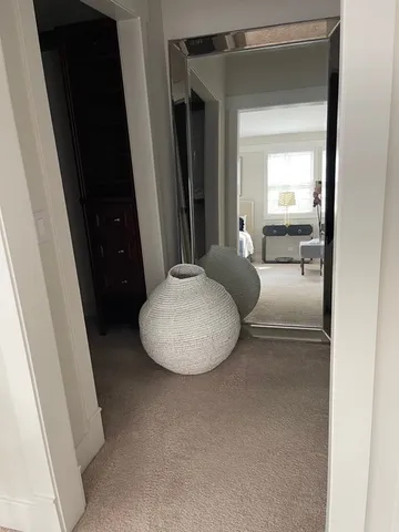 a bedroom with a bed a mirror and a large window