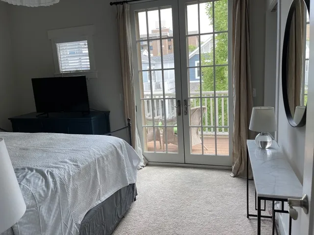 a bedroom with a bed and painting on the wall