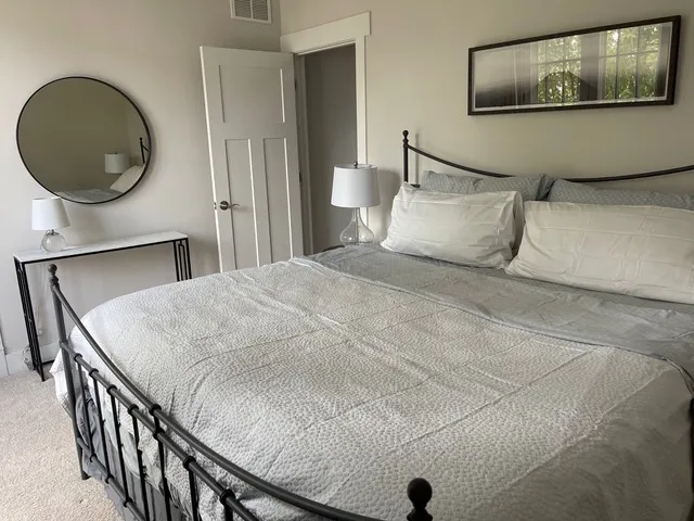 a bedroom with a bed and a wall painting