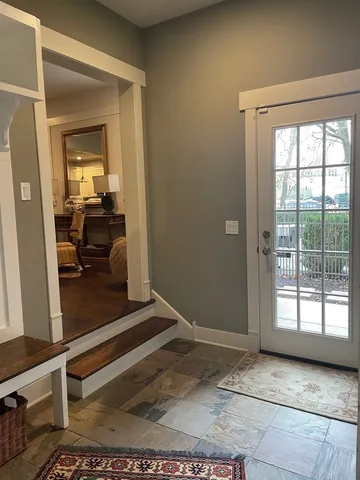 a view of a chair and tables in the balcony