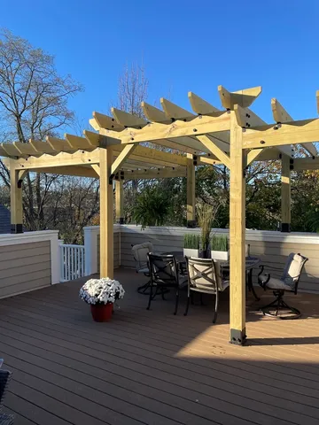 a view of a patio with a table chairs and a potted plant