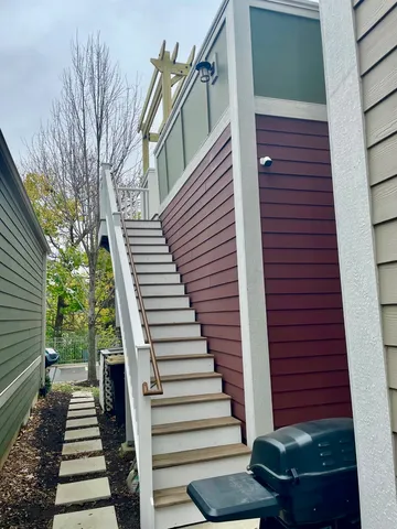 a view of a pathway with a house front with couches