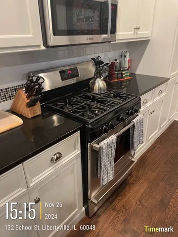 a close view of a stove a microwave and cabinets