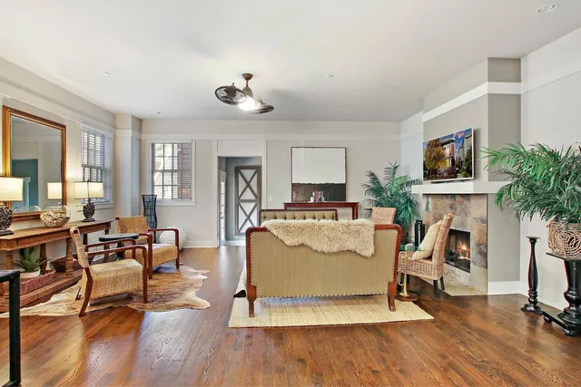 a living room with furniture a fireplace and a flat screen tv