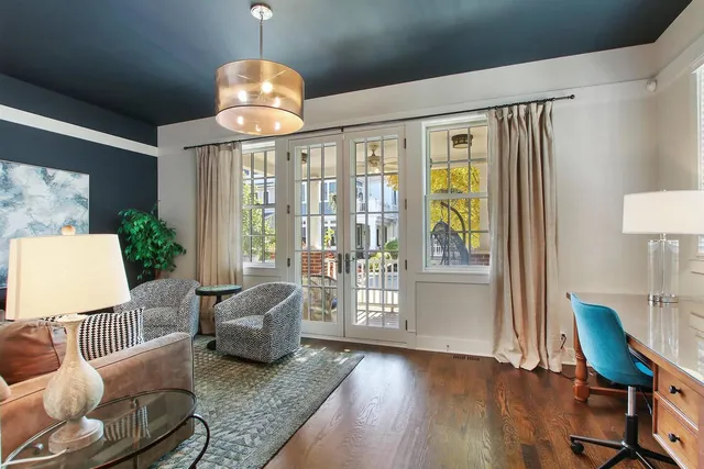 a living room with furniture and a chandelier