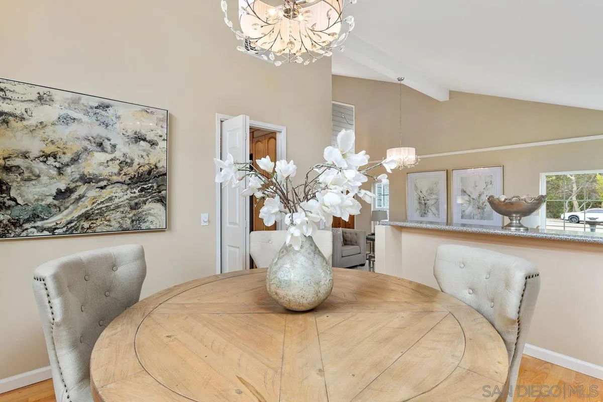 505 Willowspring Drive North Encinitas, CA 92024 - Photo 11 of 47 a view of a dining room with furniture a potted plant and a chandelier