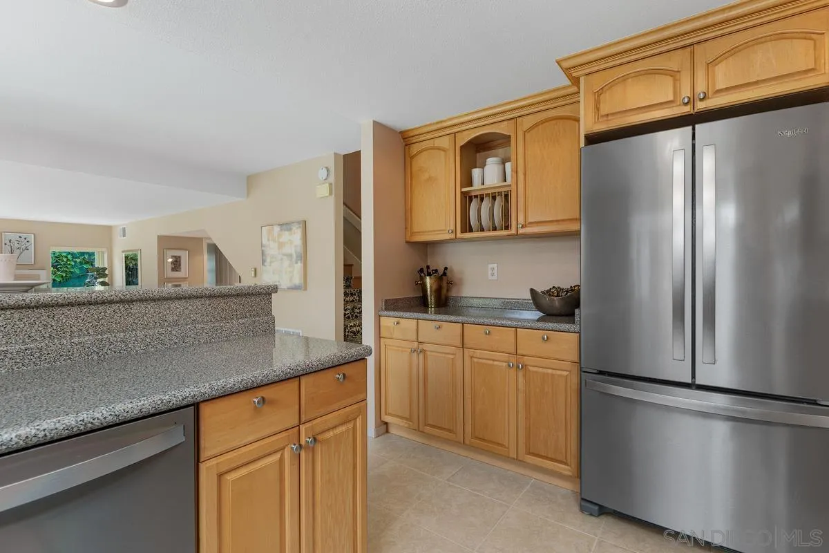 505 Willowspring Drive North Encinitas, CA 92024 - Photo 16 of 47 a kitchen with stainless steel appliances granite countertop a refrigerator and a sink