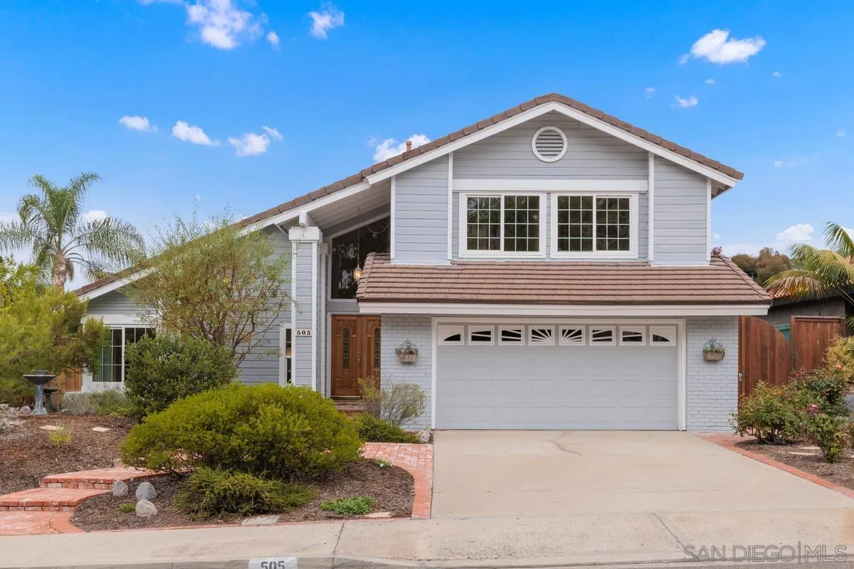 505 Willowspring Drive North Encinitas, CA 92024 - Photo 2 of 47 a front view of a house with a yard and garage