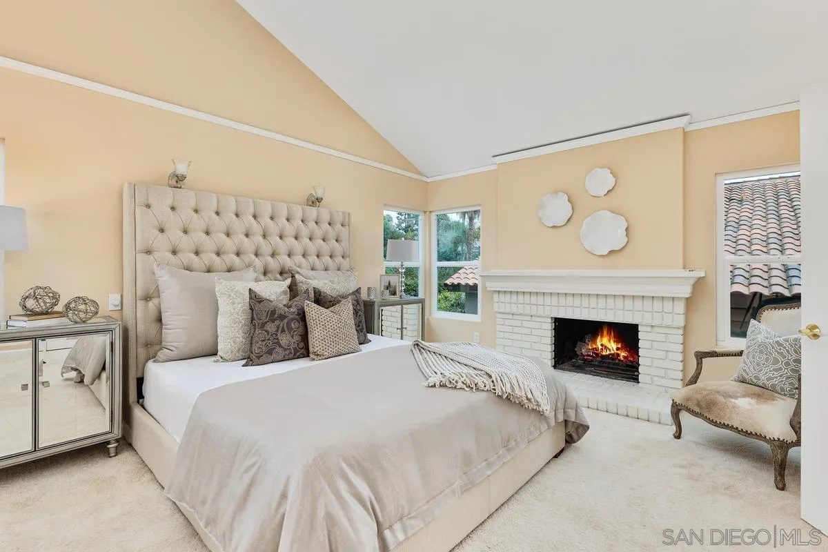 505 Willowspring Drive North Encinitas, CA 92024 - Photo 23 of 47 a bedroom with a bed and a fireplace