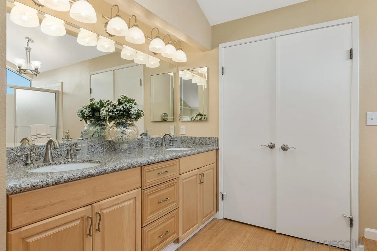 505 Willowspring Drive North Encinitas, CA 92024 - Photo 26 of 47 a bathroom with a granite countertop sink and a mirror