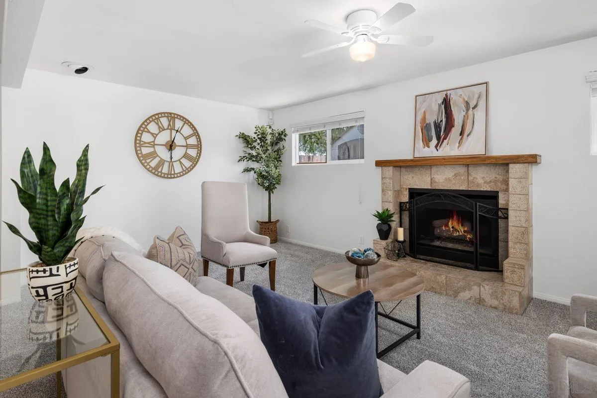 a living room with furniture a clock and a fireplace
