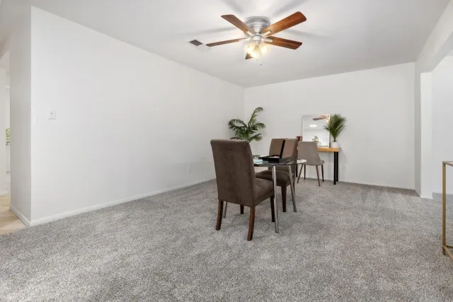 a view of a livingroom with furniture and a fan