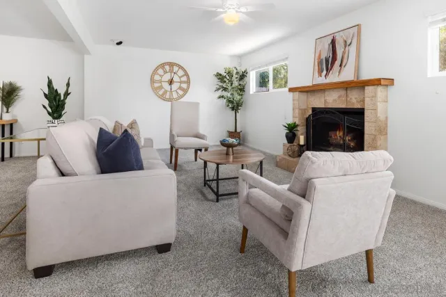 a living room with furniture and a fireplace