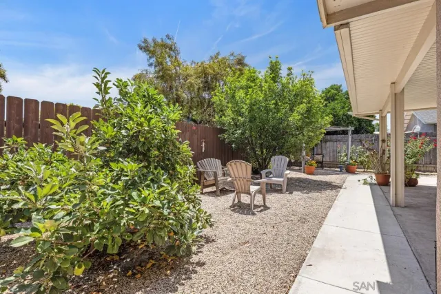 a view of a backyard with sitting area