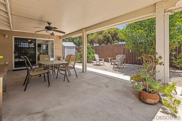a dining room with furniture water view and a floor to ceiling window