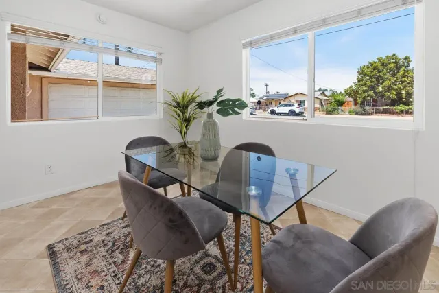 a dining room with furniture and wooden floor