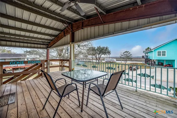 a view of a balcony with chairs and wooden floor
