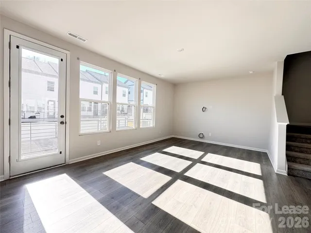 a kitchen with granite countertop a refrigerator and a stove top oven