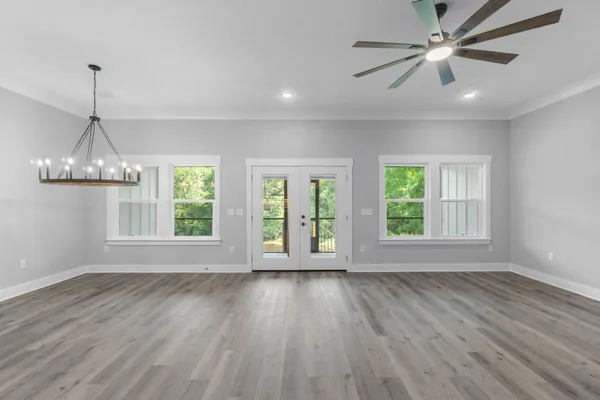 a kitchen with stainless steel appliances a clock and cabinets