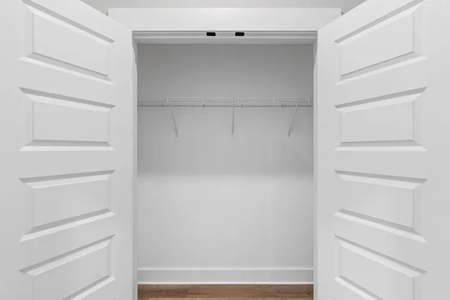 a view of an empty room and wooden floor