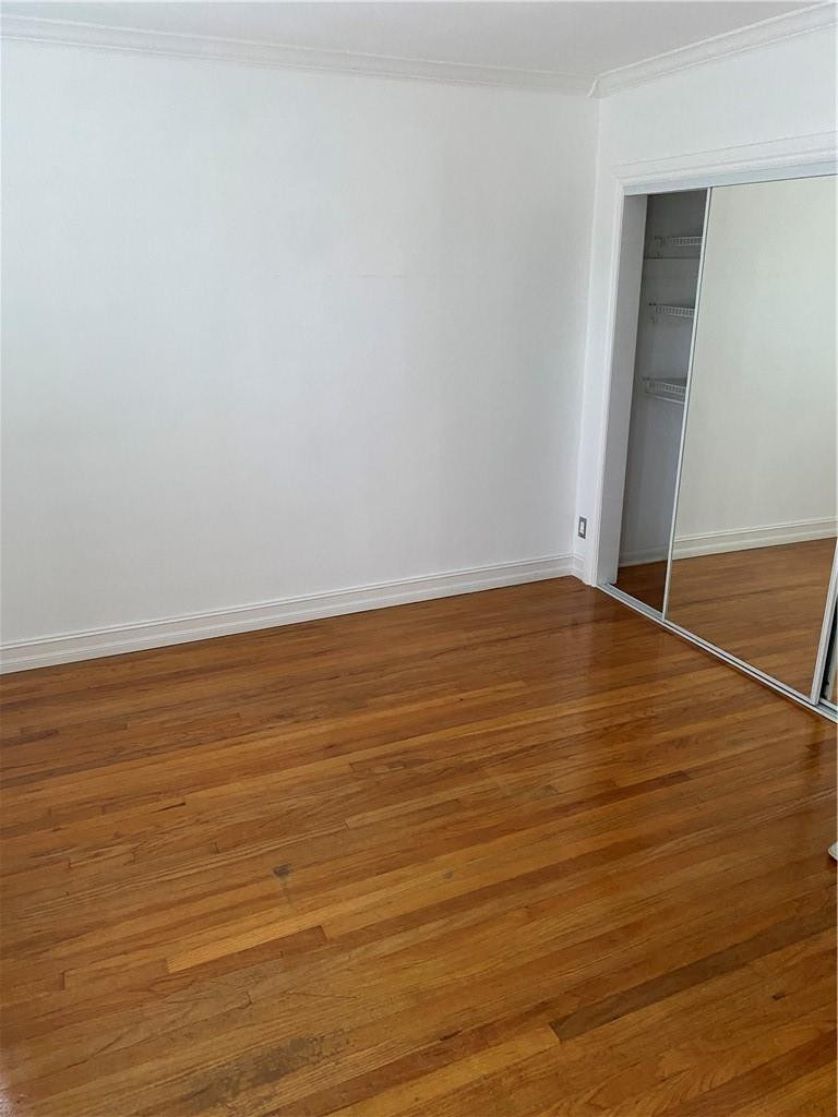 1430 Northeast 4th Court Boca Raton, FL 33432 - Photo 14 of 15 a view of an empty room with wooden floor