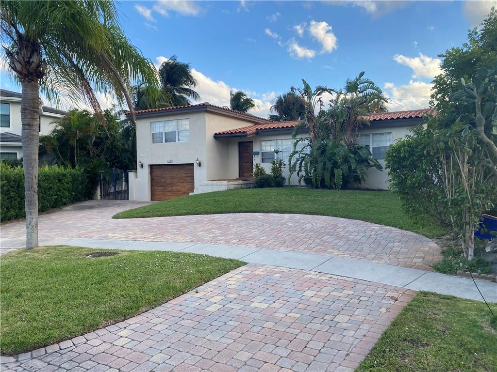 1430 Northeast 4th Court Boca Raton, FL 33432 - Photo 2 of 15 a view of a house with a yard and palm trees