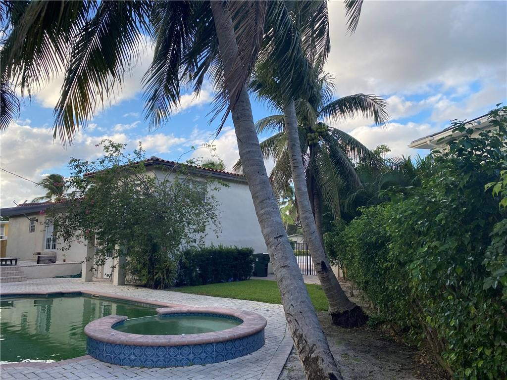 1430 Northeast 4th Court Boca Raton, FL 33432 - Photo 6 of 15 a swimming pool with outdoor seating and plants