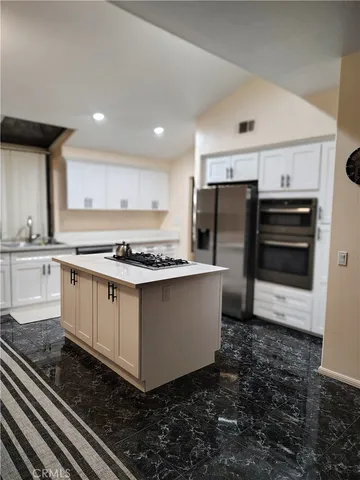 a kitchen with a appliances and cabinets