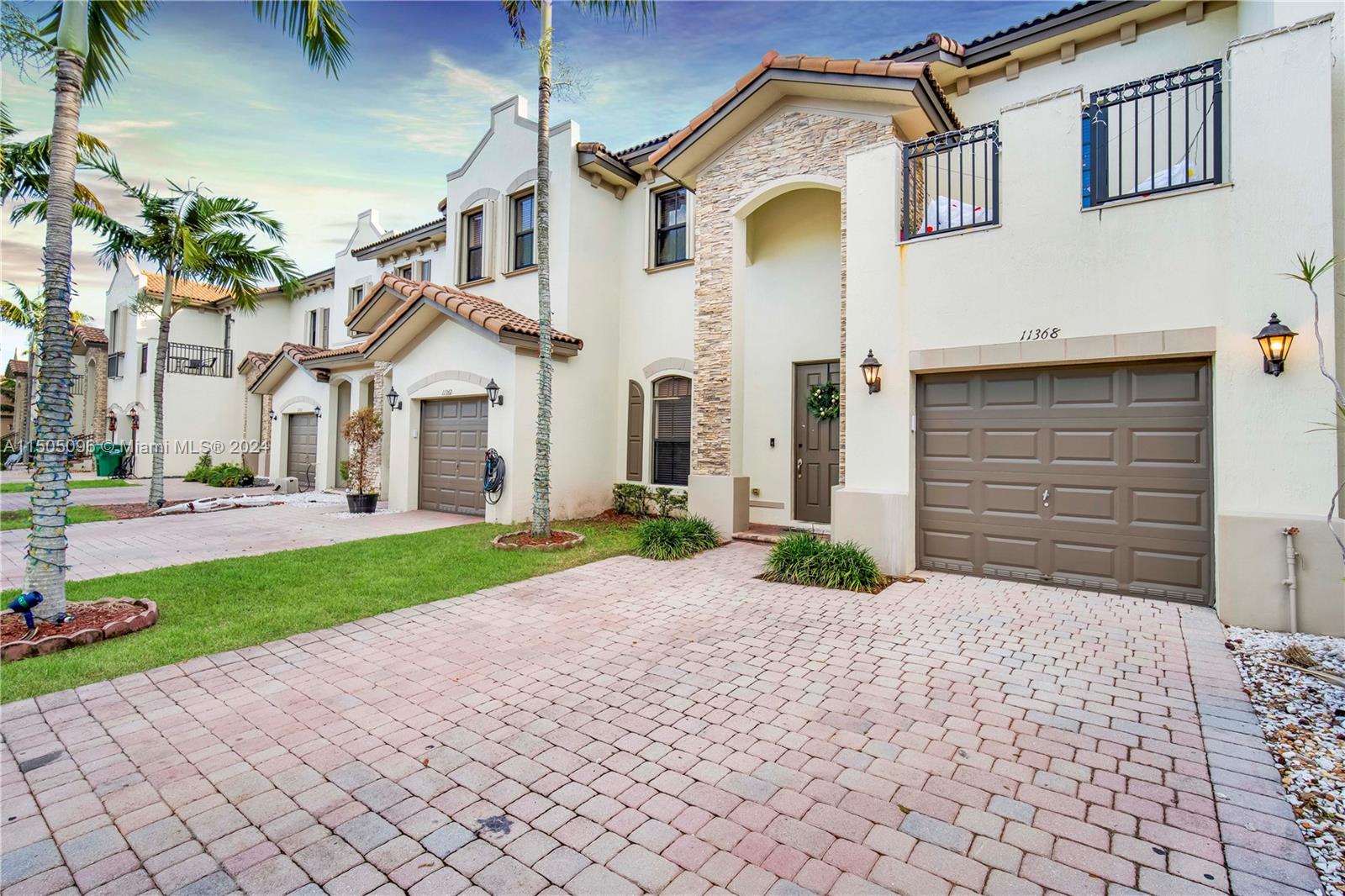 11368 Southwest 238th Street Homestead, FL 33032 - Photo 5 of 18 a front view of a house with a yard and garage