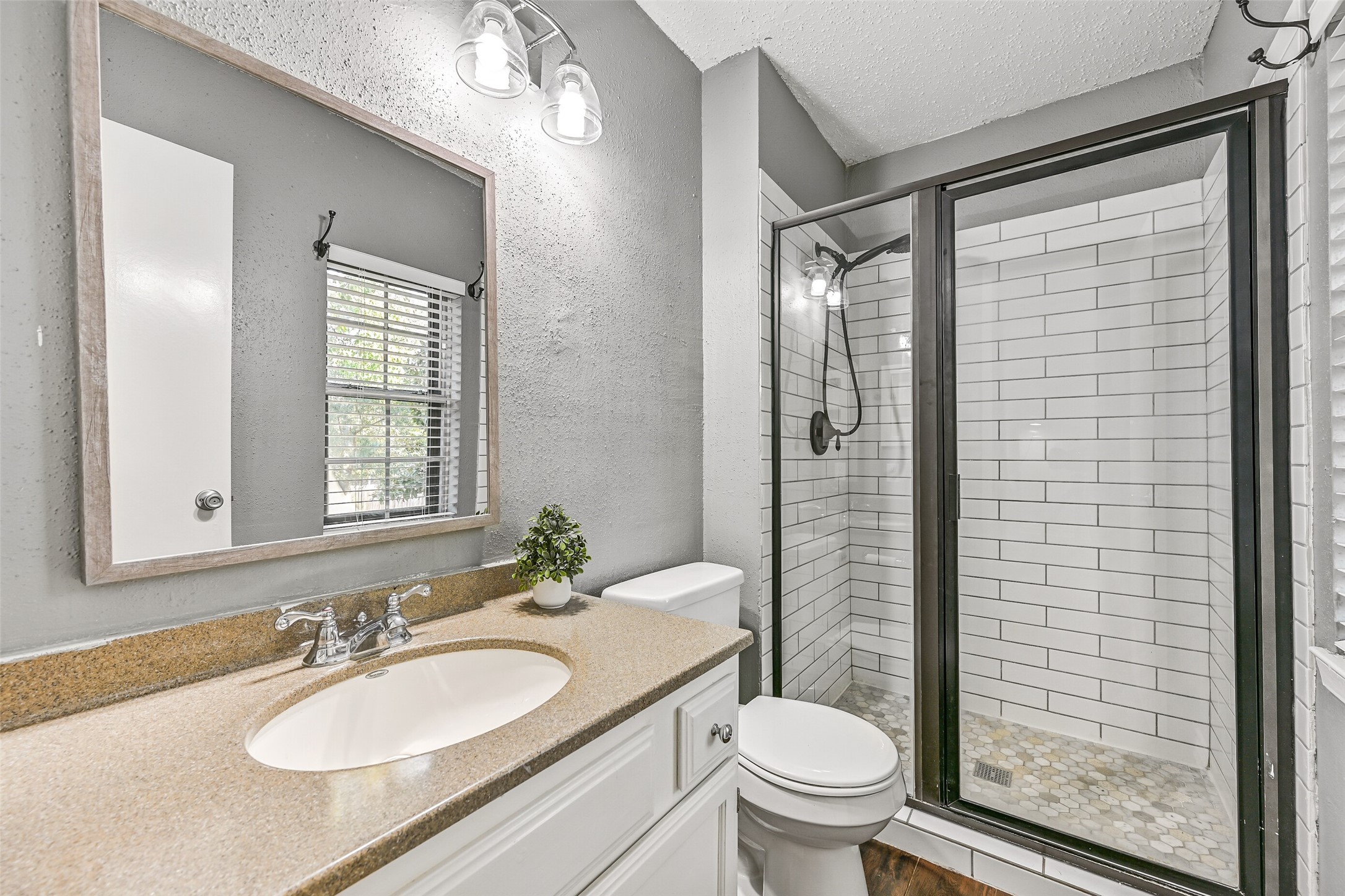 2503 Colleen Drive Pearland, TX 77581 - Photo 14 of 23 a bathroom with a granite countertop sink toilet a mirror and shower