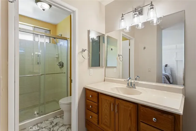a bathroom with a double vanity sink mirror and shower