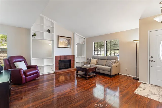a living room with furniture wooden floor and a fireplace